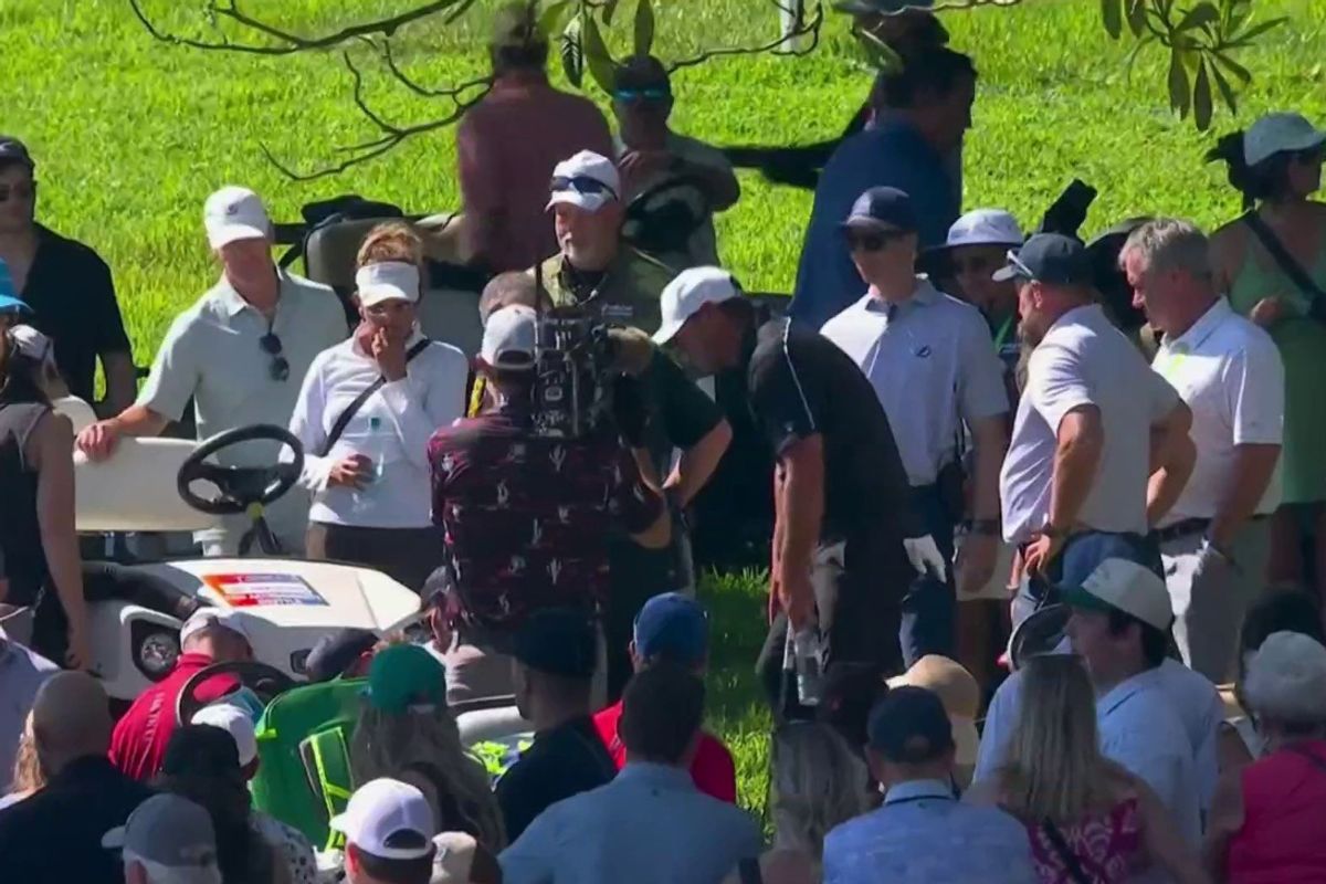 Brooks Koepka helps the girl stuck by a cart. 