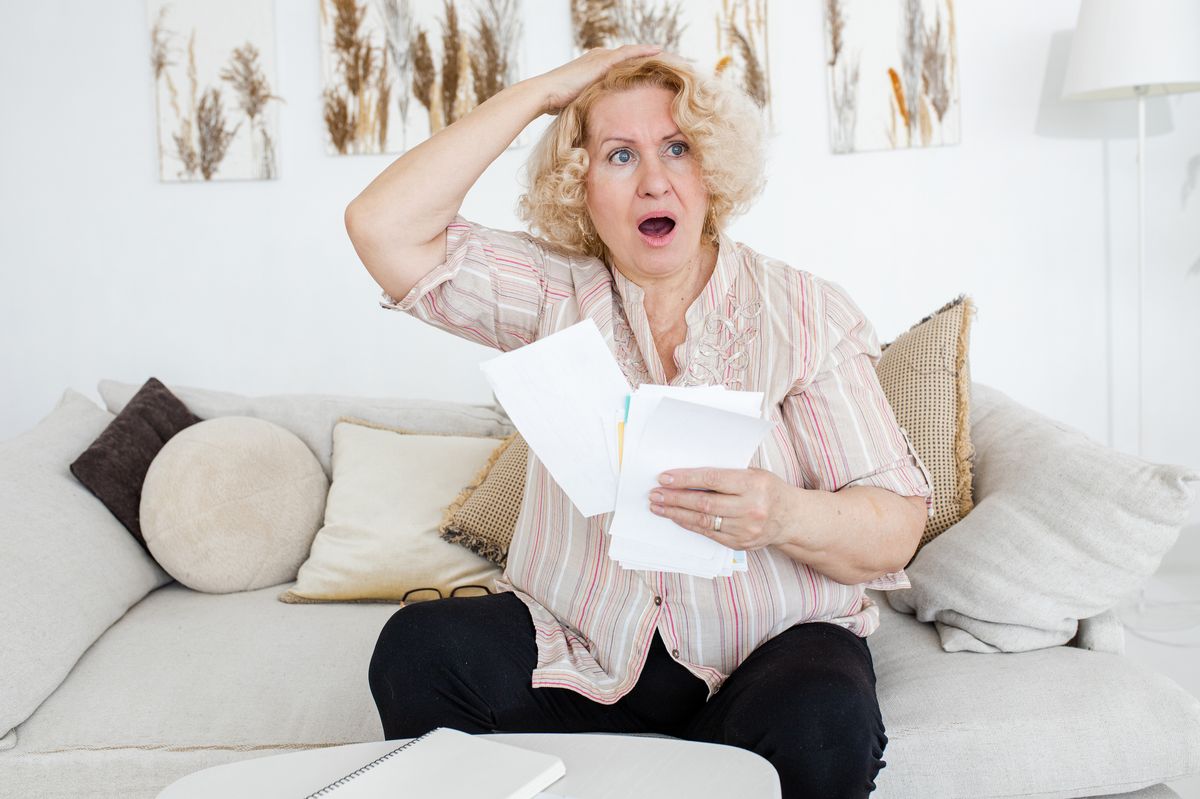Shocked pensioner reading a letter