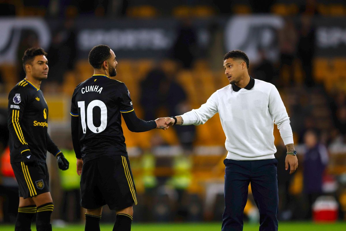Joao Gomes of Wolverhampton Wanderers (R) greets fellow Brazilian players Matheus Cunha and Casemiro of Manchester United following the Premier League match between Wolverhampton Wanderers and Manchester United at Molineux on December 08, 2025 in Wolverhampton, England.