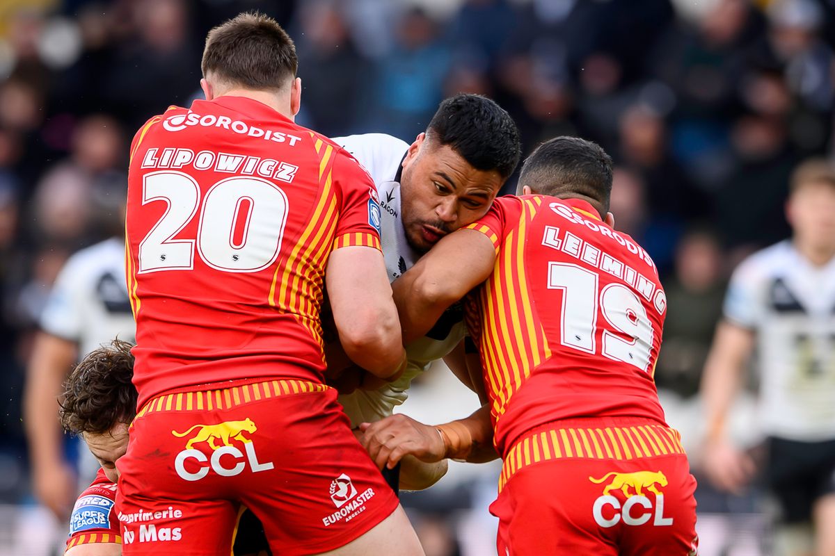 Hull FC's Sam LIsone is tackled by Catalans' Zac Lipowicz & Kruise Leeming.