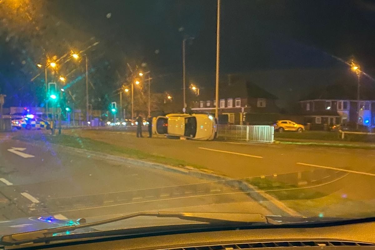 Car on its side on Utting Avenue by Queens Drive in Walton