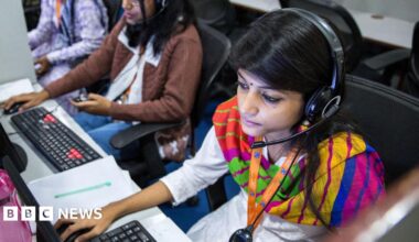 Employees wear headsets while working at the Avise Techno Solutions LLP call center in Kolkata, India, on Sunday, Dec. 24, 2017.