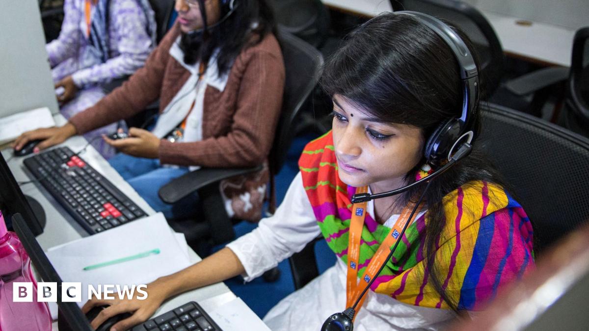 Employees wear headsets while working at the Avise Techno Solutions LLP call center in Kolkata, India, on Sunday, Dec. 24, 2017.