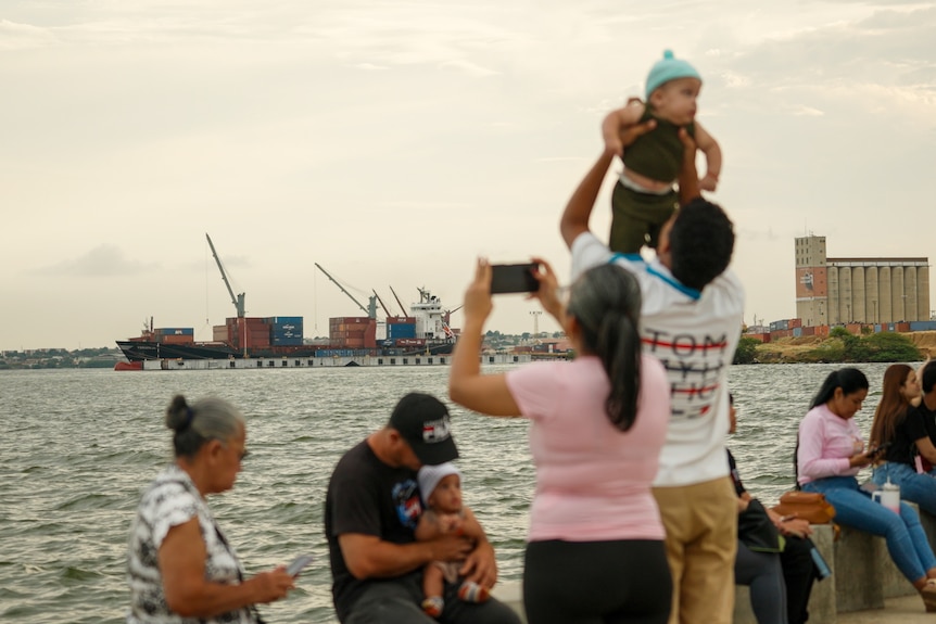 Ships with tourists in the foreground.