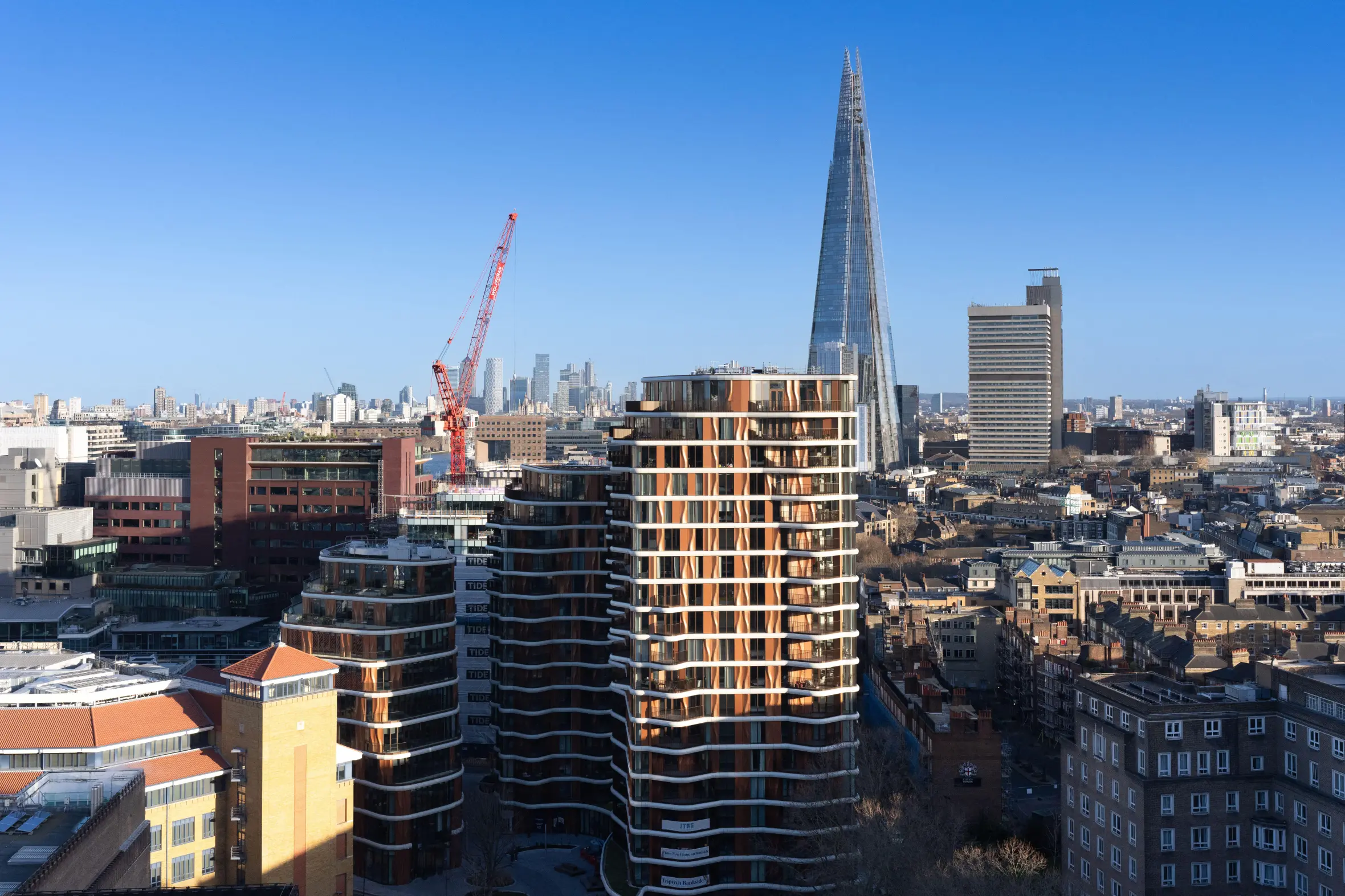 Modern apartment buildings in Triptych Bankside, London, with The Shard in the background.