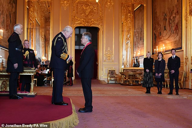Sir Kazuo Ishiguro, pictured in November last year with the King, is one of the authors named on the empty book to protest against AI stealing the work of creatives
