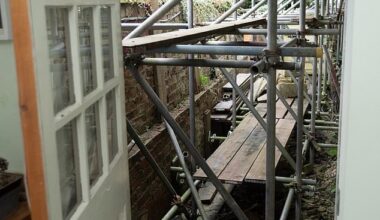 Pictured: The scaffolding, which is visible as soon as Mr Ewart-James opens his back door
