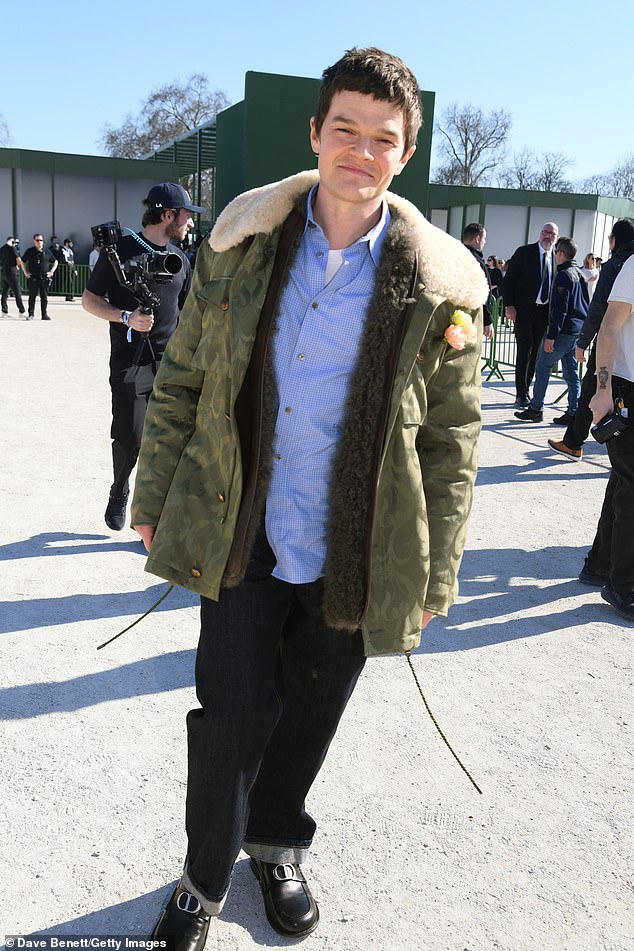 Robert smiled as he stood outside at the venue before the show