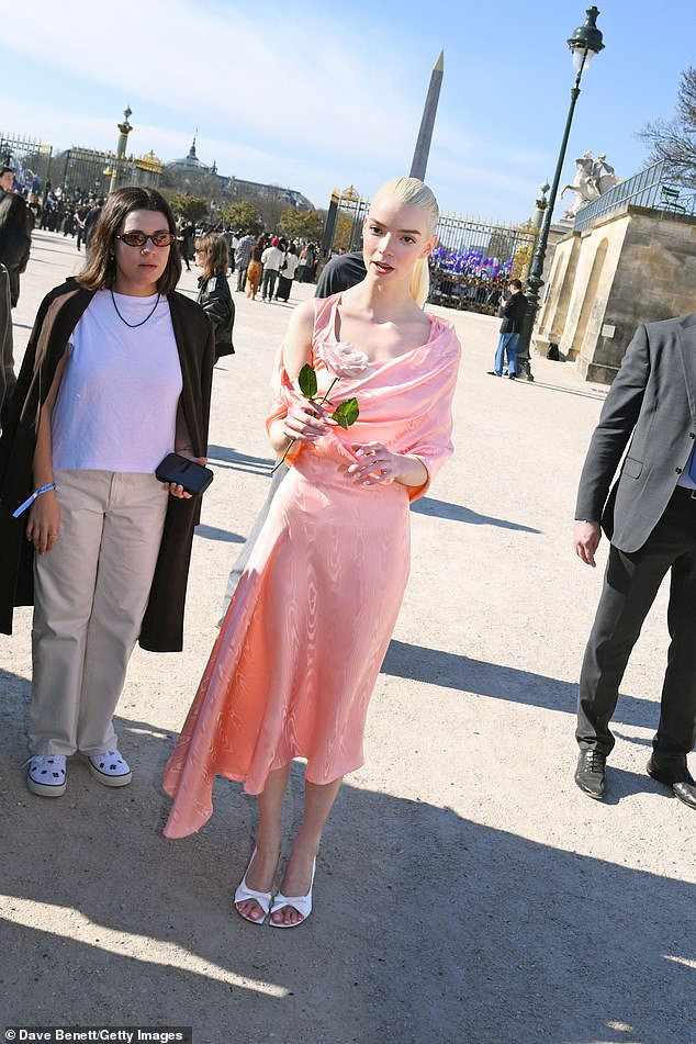 The actress, 29, cut an elegant figure in a pink silk midi dress with draped detailing across the shoulders, teamed with a pair of white bow shoes