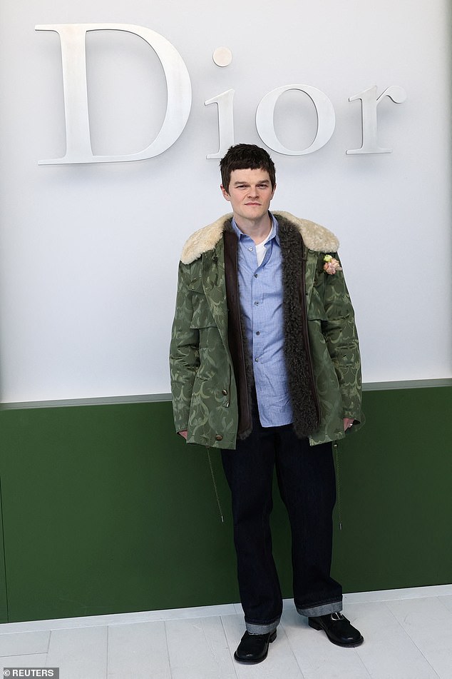 I Swear actor Robert Aramayo rocked a camouflage jacket, blue shirt and jeans