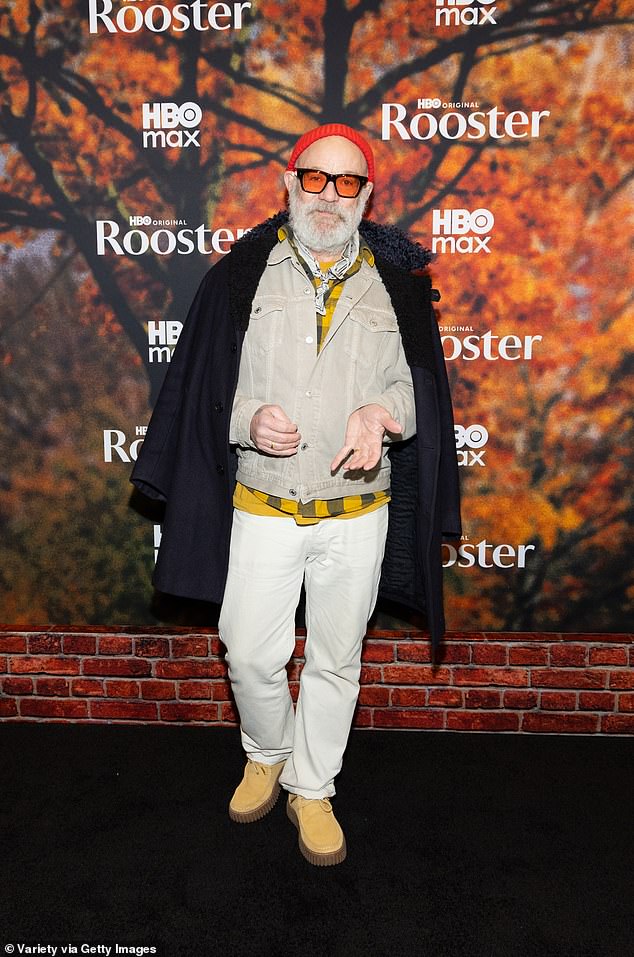 Former REM frontman Michael Stipe was layered up with a gray denim jacket and white jeans, with a yellow plaid shirt and matching yellow moccasins to add some color. He completed the look with a black cashmere jacket draped over his shoulders, and he covered up with a red beanie