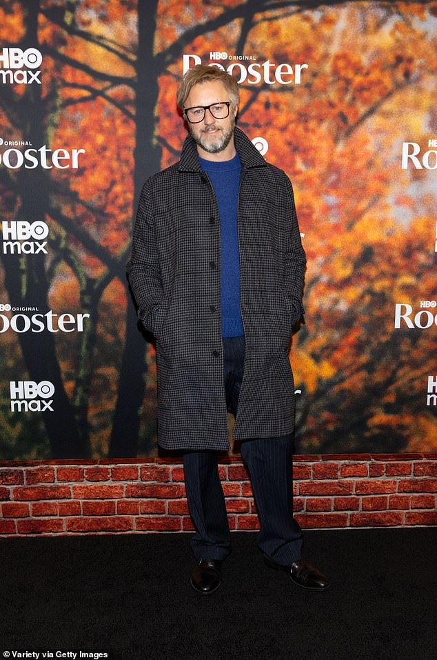 Fellow comedian and actor, Rory Scovel, opted for a tasteful gray plaid overcoat with a royal blue sweater, black pinstripe trousers and black leather shoes