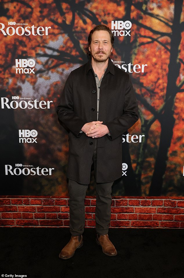 Righteous Gemstones actor Scott MacArthur arrived in a thin black coat with a gray button-sup shirt, dark jeans and brown Chelsea boots