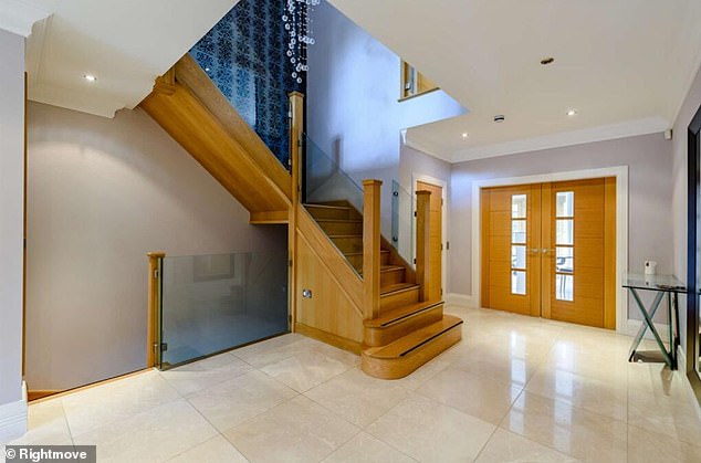 A charming wooden staircase leads upwards from the hallway of Evra's mansion