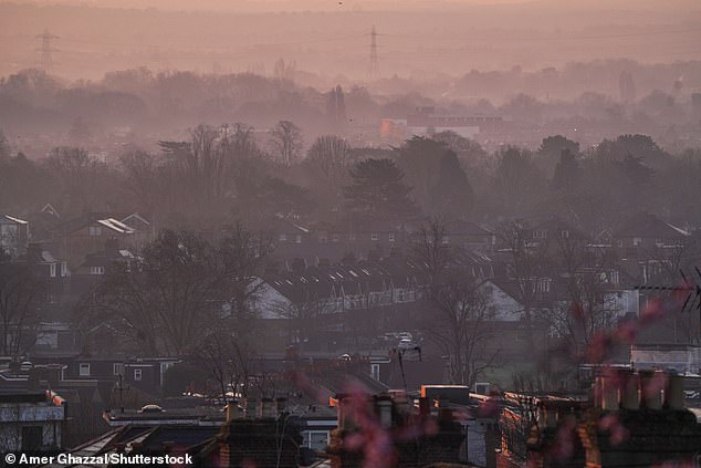 The sky over Wimbledon in South West London appears hazy at sunrise this morning