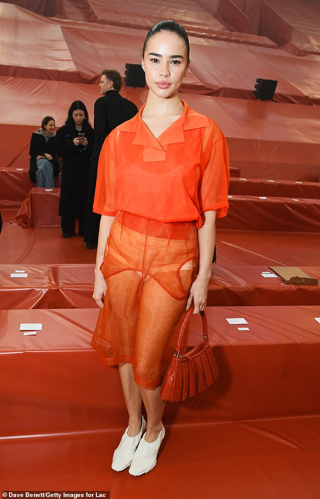 Edie Liberty Rose turned heads in a sheer, bright orange skirt, white heels and a simple orange polo top