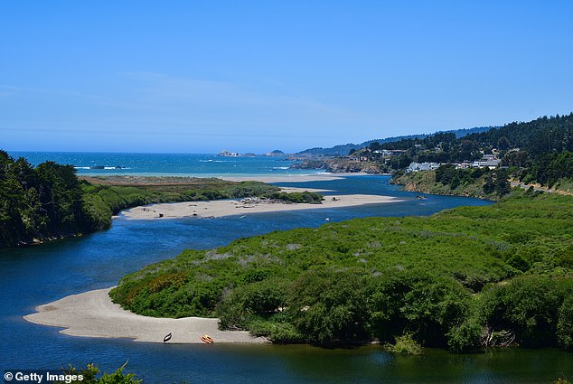 Scenic view overlooking the Gualala River converging with the Pacific Ocean with the town of Gualala in the distance