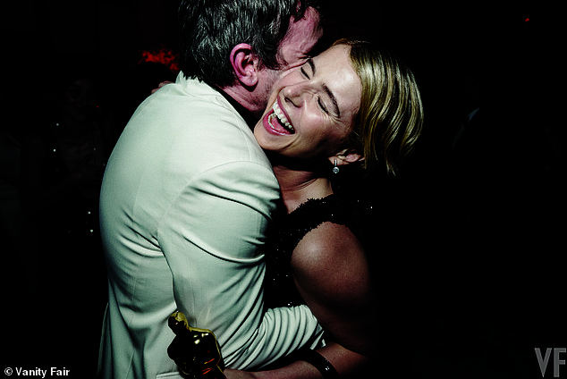 Jessie Buckley embracing her co-star Paul Mescal as she holds her Oscar