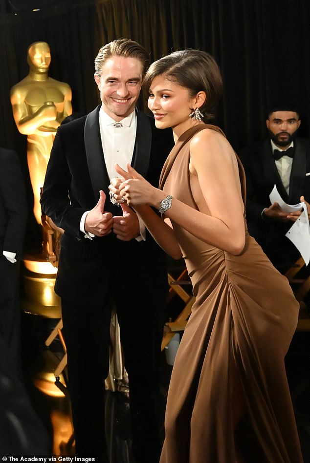 Zendaya with her thumbs up, as she stood beside Pattinson, with whom she presented an award during the show