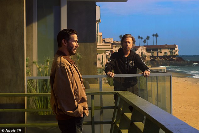 Here Reeves is seen at a beach house with David Spade, right