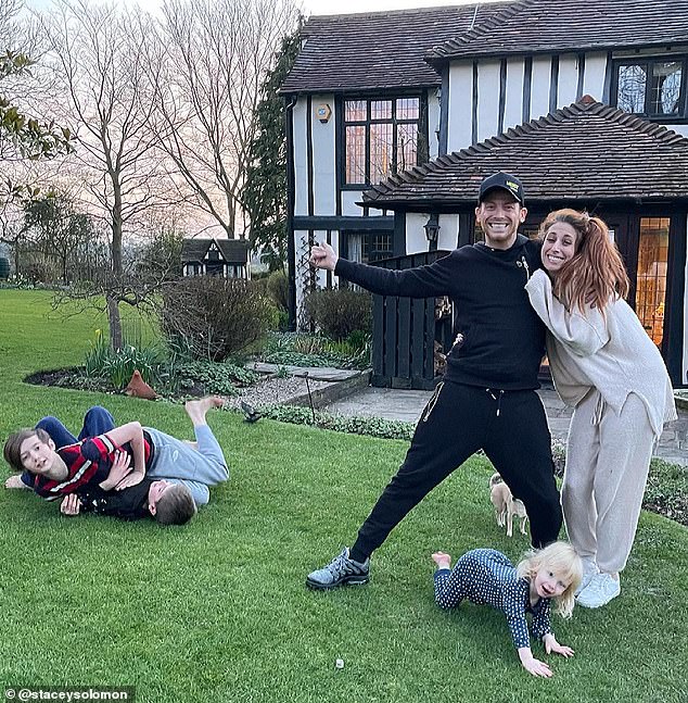 The pair pose in front of the £1.2million five-bedroom home in Essex