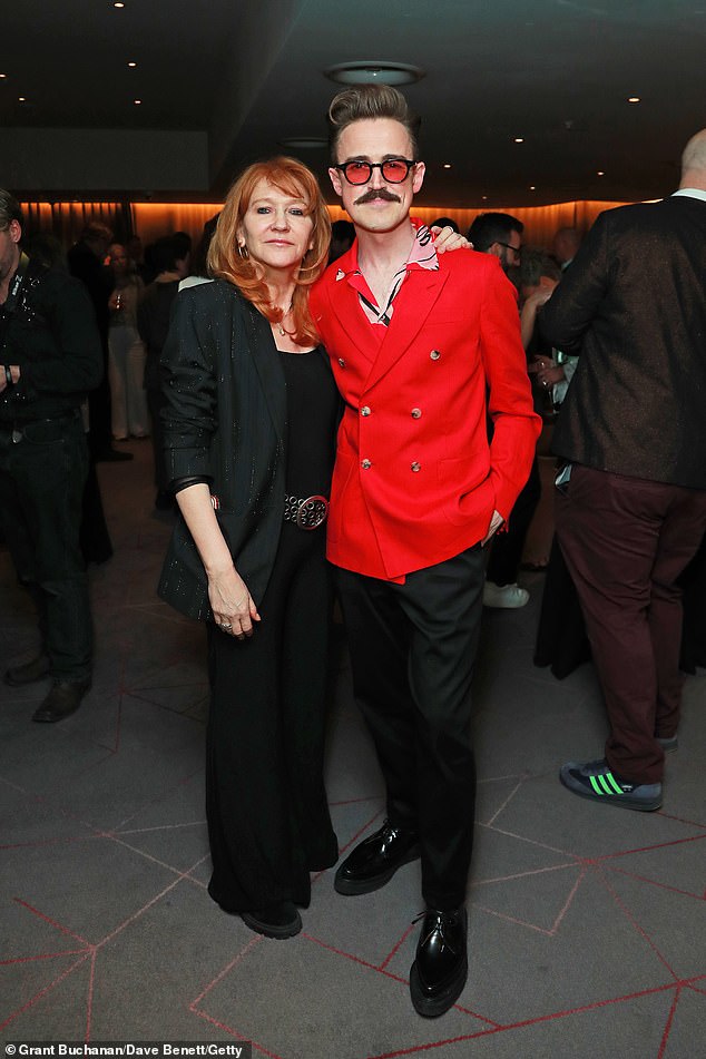 Tom looked incredibly dapper in a red velour suit blazer which he teamed with a pink and black shirt underneath (pictured with Sonia Friedman)