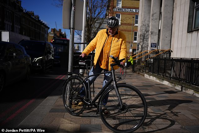 James May arrives by bicycle at Lavender Hill Magistrates' Court in South London today