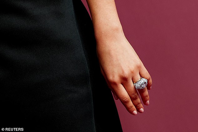 She paired the look with black heels and dazzling jewellery, including what is believed to be her wedding band