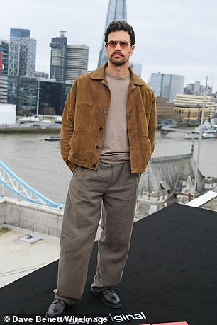 Theo James appeared to recreate Daniel Craig's 007 pose overlooking the London skyline at a photocall for their new movie Fuze on Friday