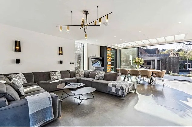 The listing on Rightmove states: 'Designed by Flint Architects, the home has an imposing exterior which includes grey bricks and silvered timber alongside a wide range of striking design features'