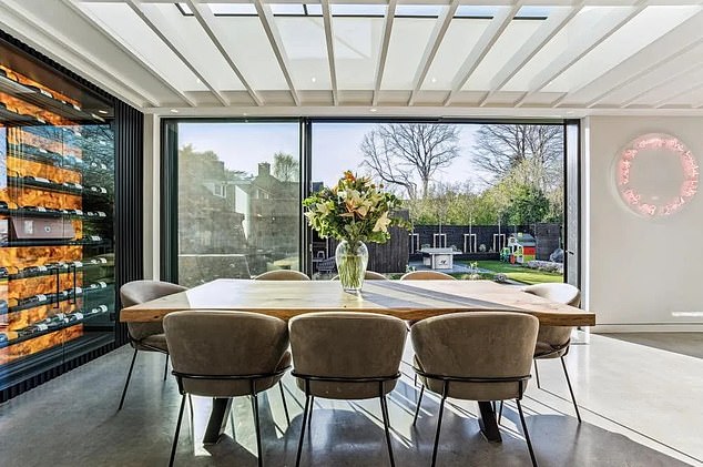 This standout property features seven bedrooms, a private gym, and a media room, complemented by a vaulted lobby, an entertainment zone, and an outdoor summer house