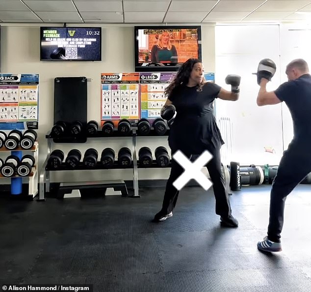 Showing off her padwork skills, Alison completed her workout look with chunky black trainers