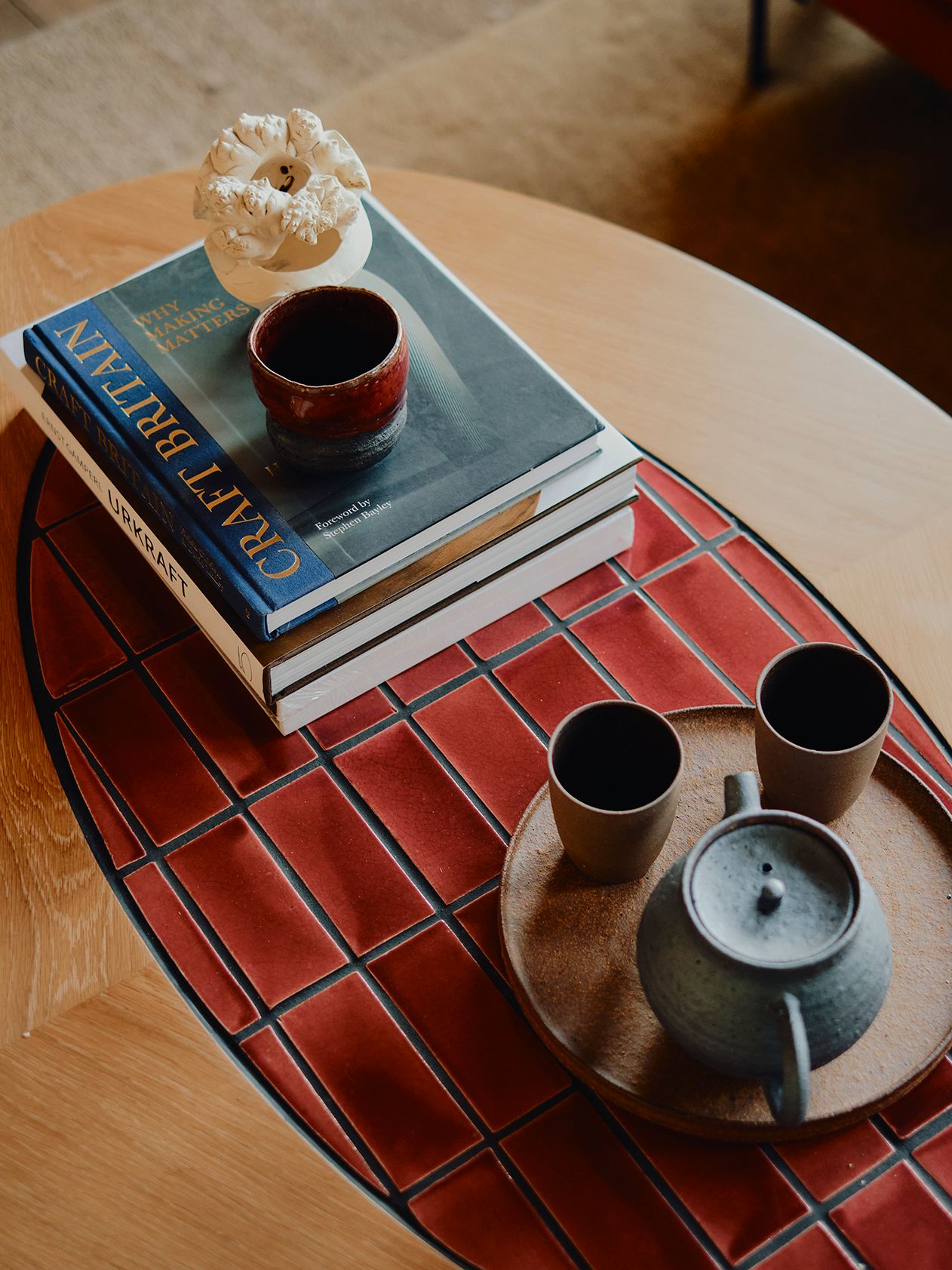 Image may contain Furniture Table Book Publication Coffee Table Tabletop Ammunition Grenade Weapon and Cup