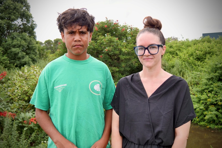 Lionel Saunders and his mother Stephanie Kirsop looking at camera in front of creek bank