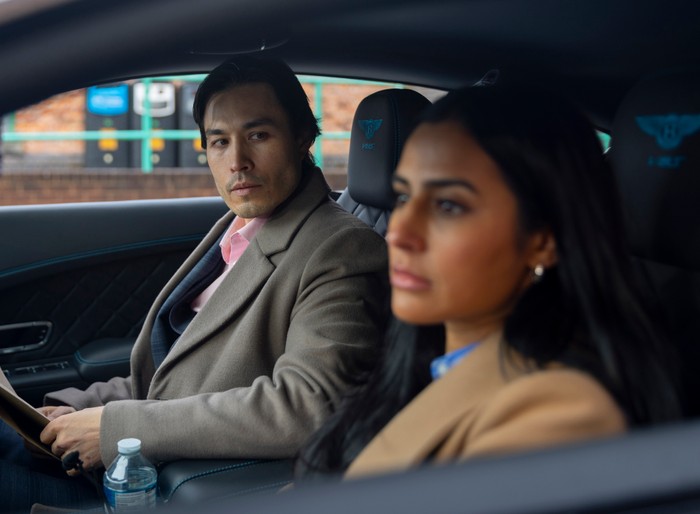 Alya sits in a car with Rich in a scene from Coronation Street