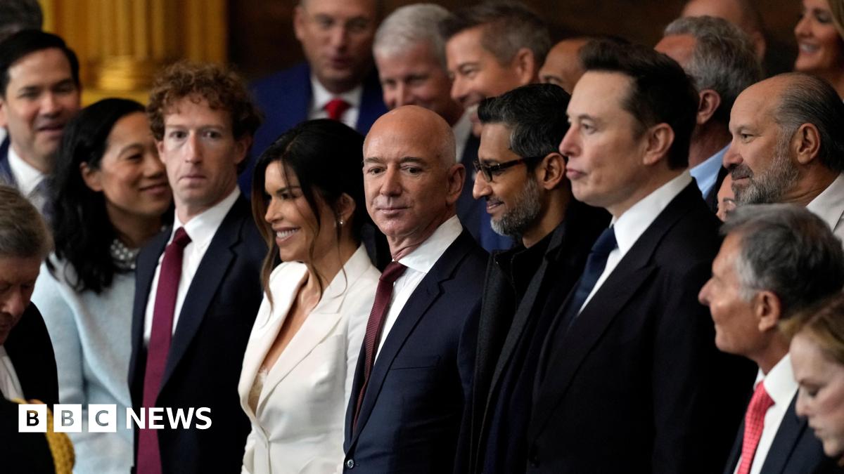 Appearing at the second inauguration of Donald Trump, from left to right: Mark Zuckerberg in a black suit, white dress shirt and red necktie; Jeff Bezos in a navy suit, white dress shirt and red neck tie; Sundar Pichai in an all black suit, shirt and neck tie; Elon Musk in a black suit, white dress shirt and navy neck tie