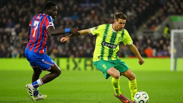 Marcus Rohden of AEK Larnaca controls the ball under pressure from Ismaila Sarr of Crystal Palace