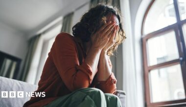 Students queue for antibiotics outside a building at the University of Kent in Canterbury.