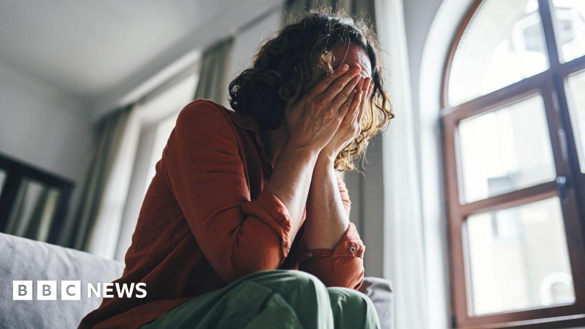 Students queue for antibiotics outside a building at the University of Kent in Canterbury.