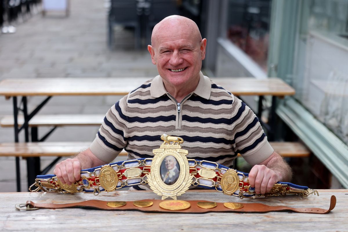 Steve proudly shows off his British and inaugural Welsh featherweight belts