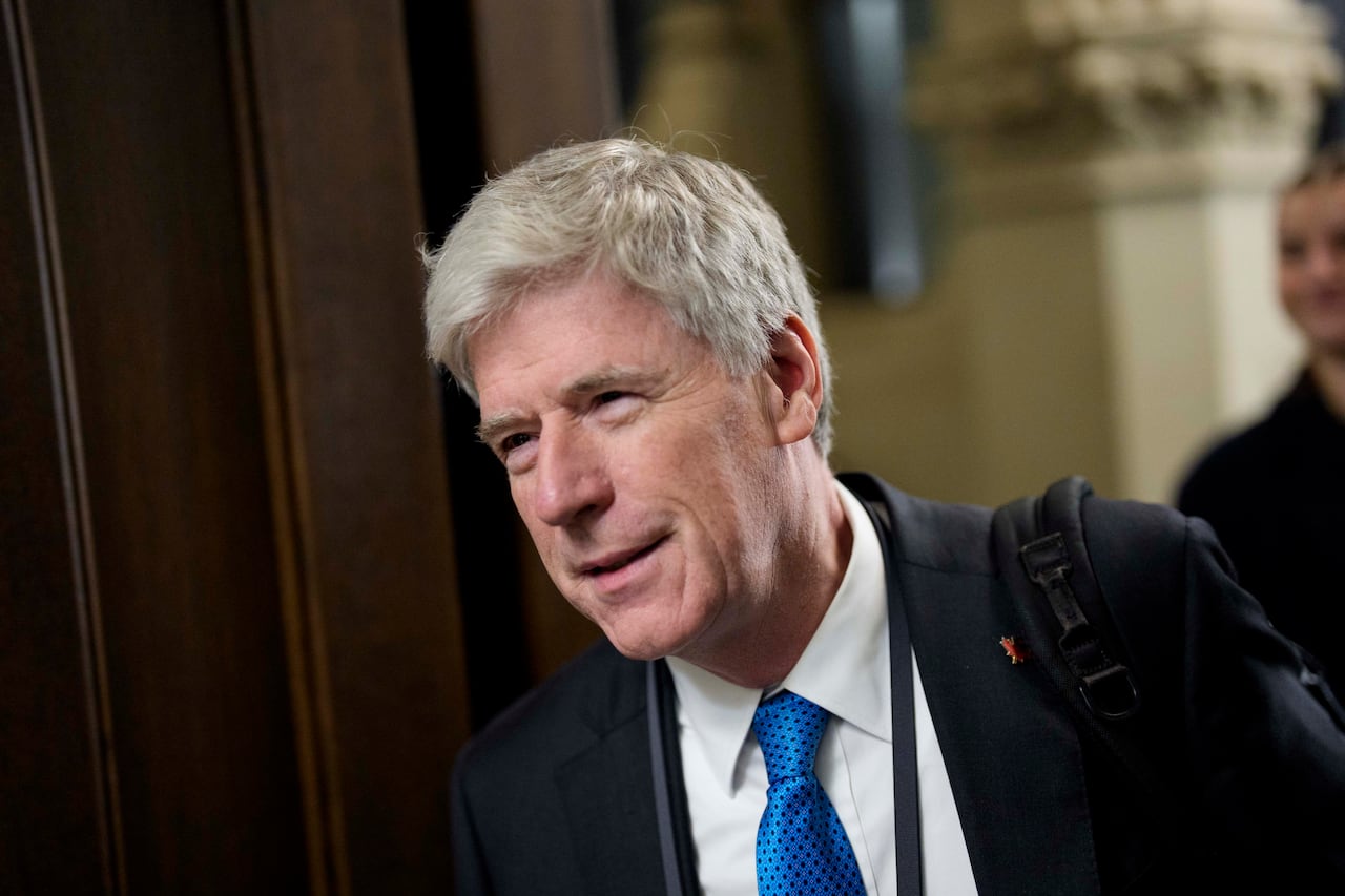 A man in a suit and blue tie