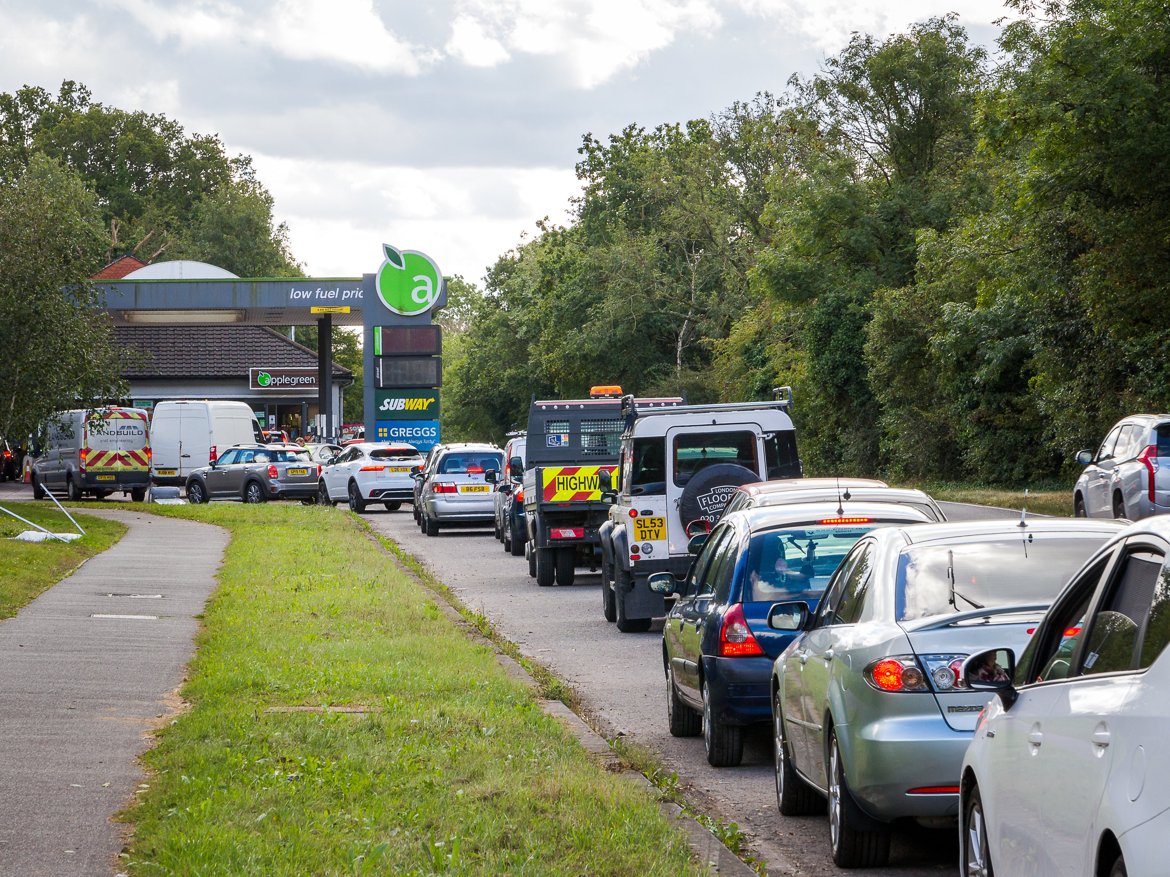 Cars queue up to fill up with petrol at the gas station during a fuel shortage in September 2021