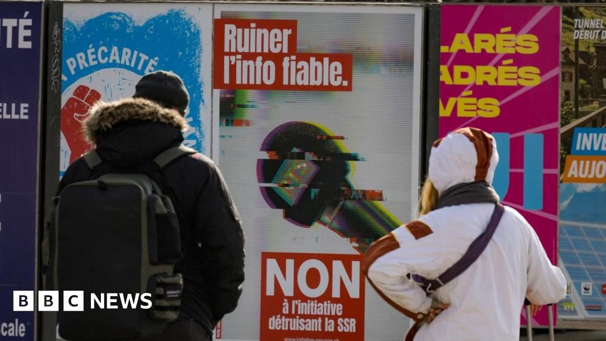 People in Geneva look at a poster urging people to vote "No" to funding cuts for the Swiss Broadcasting Corporation. Photo: February 2026