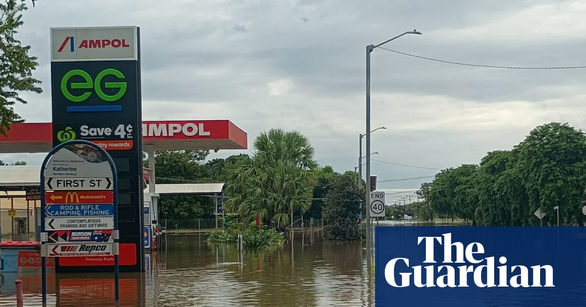‘A saltwater crocodile on the AFL oval’: worst flooding in decades inundates NT as residents urged to avoid water | Flooding