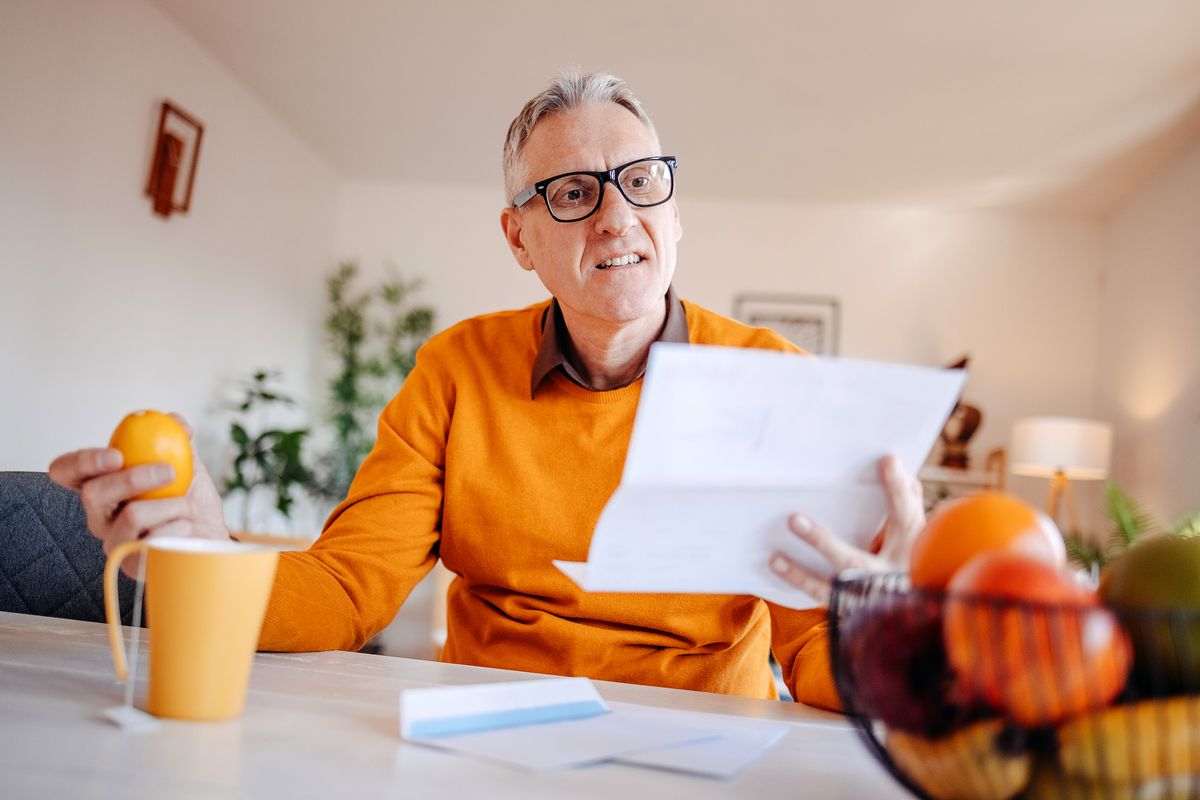 Shocked pensioner reading a letter