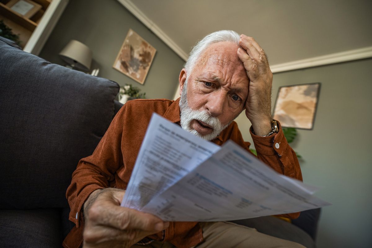 Shocked pensioner reading a letter