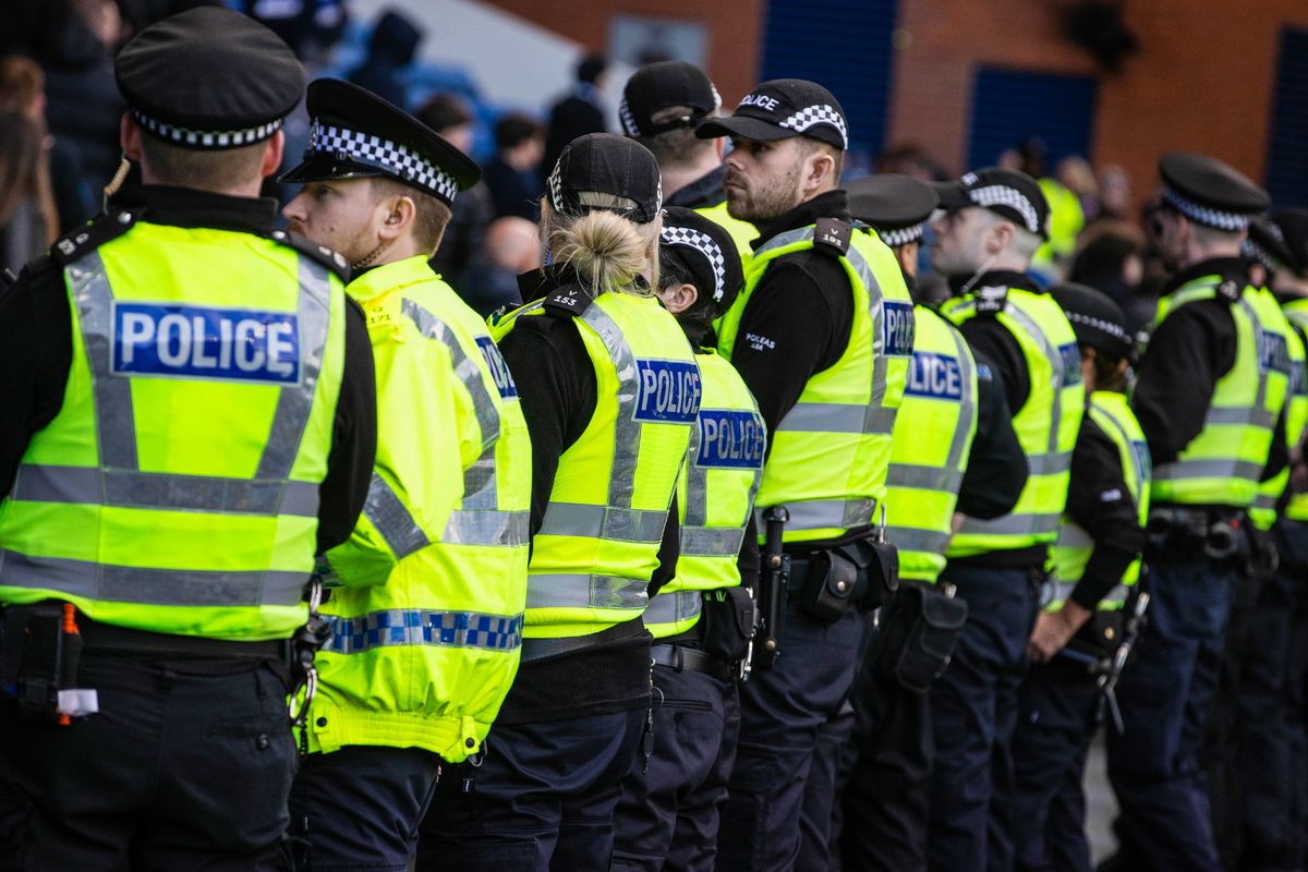 Police line up to block fans from storming the pitch at full time