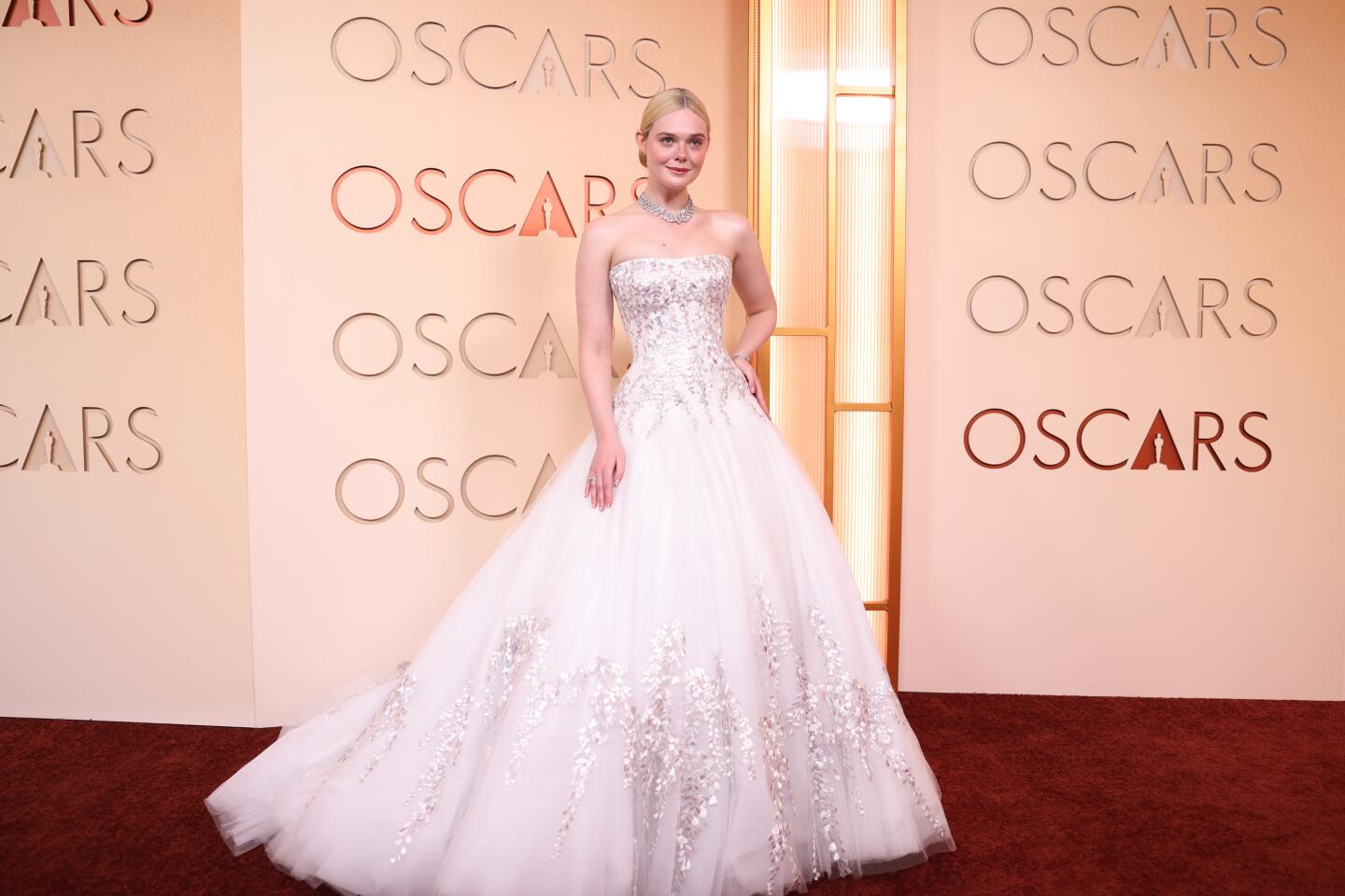Elle Fanning arrives on the red carpet in a strapless white sparkly ball gown