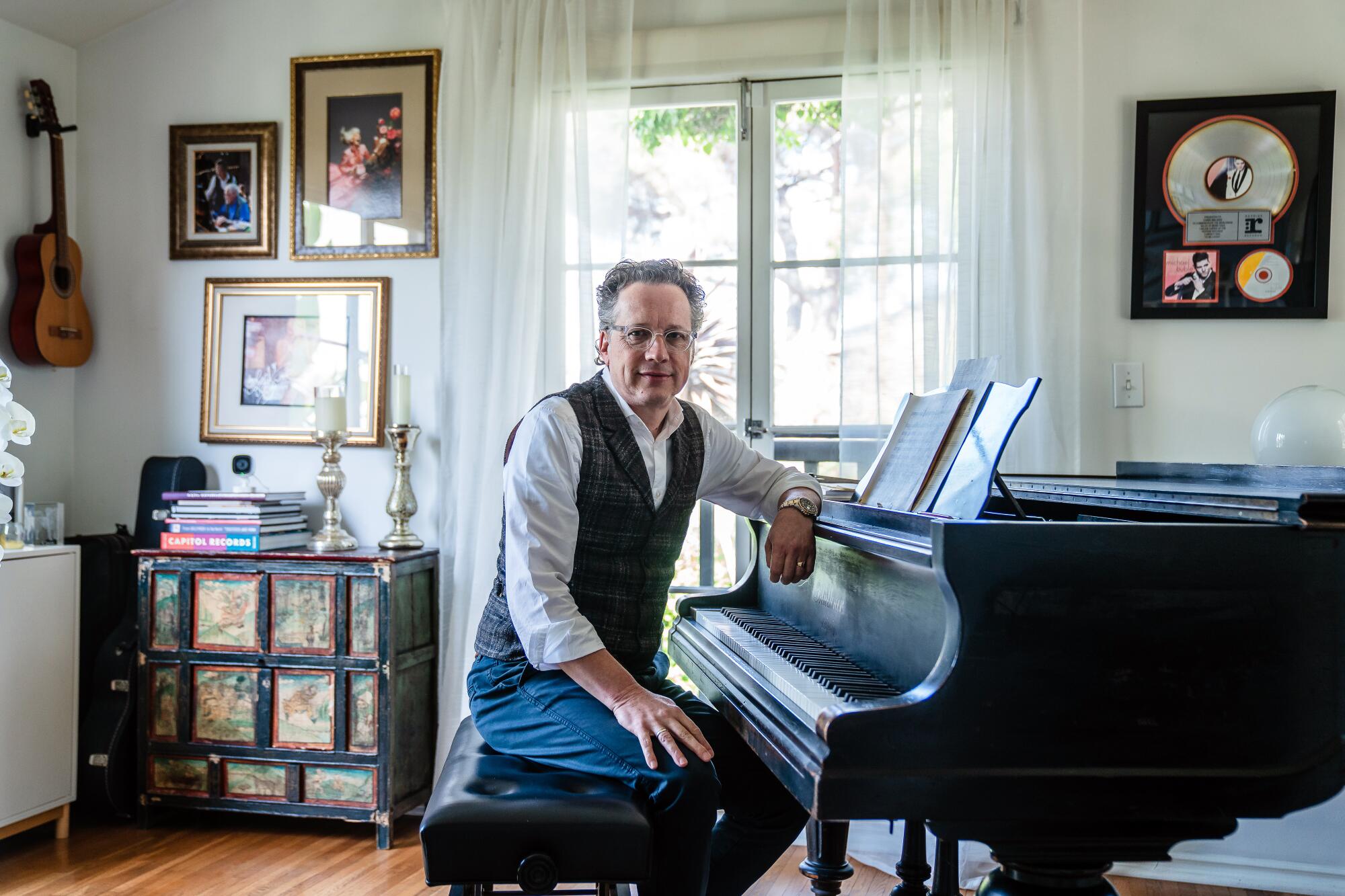 A man sits at his piano.