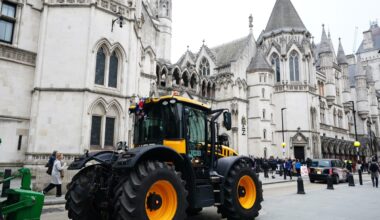 Farmers rally outside high court, holding protest signs and banners, advocating for agricultural rights and policy changes.